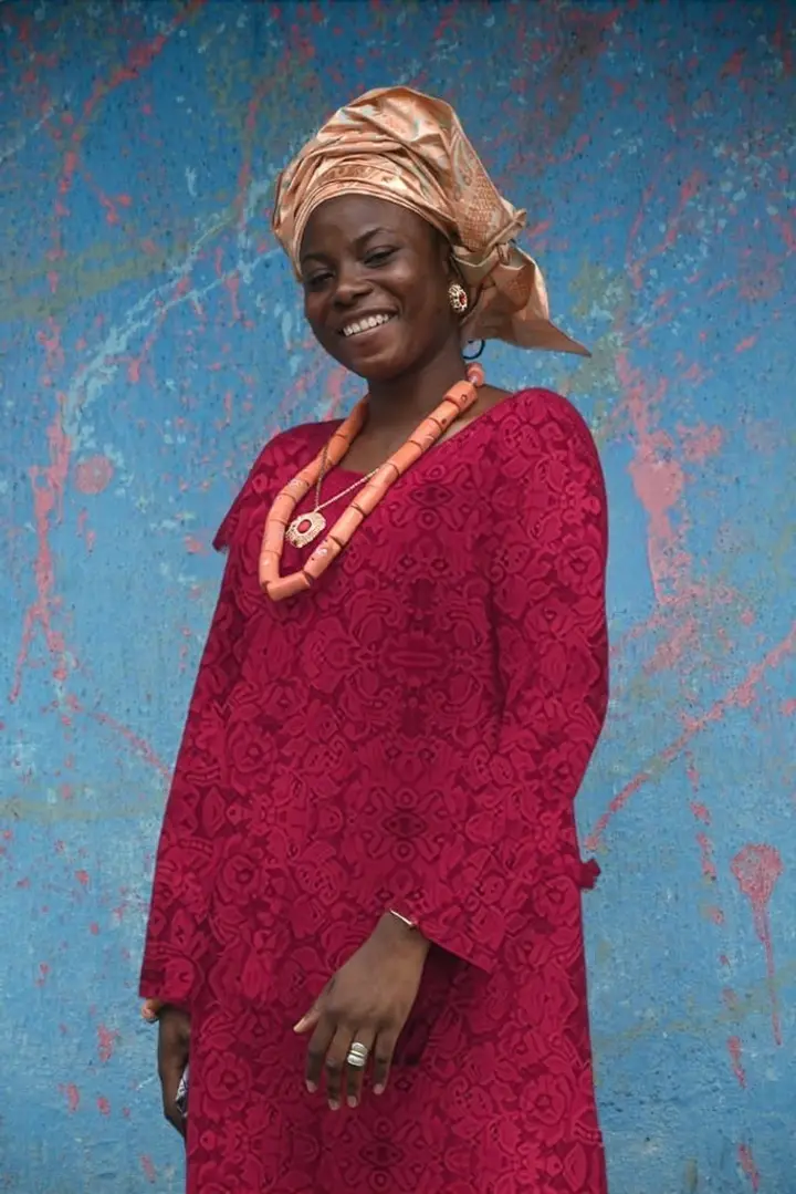 A wedding guest wearing a wine lace kaftan, generated from her own photo and the fabric